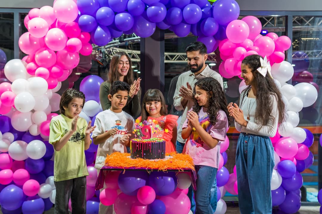 Family gathered around the birthday cake