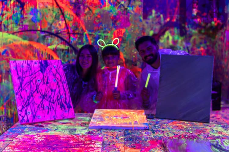 Family showing their painted canvases